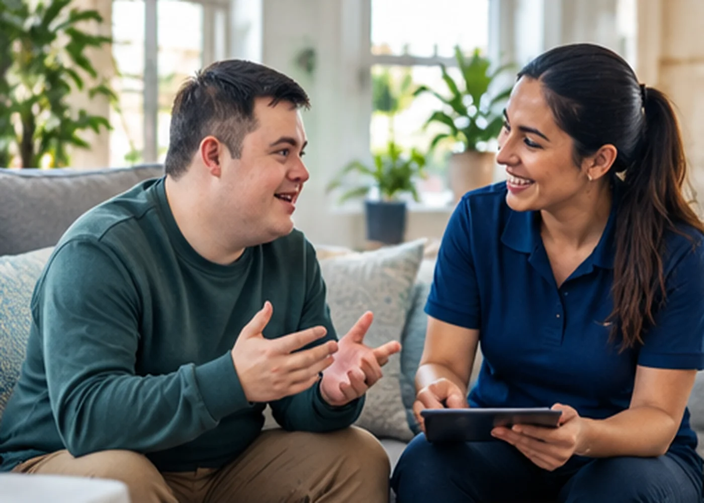 A support worker and adult having a relaxed conversation